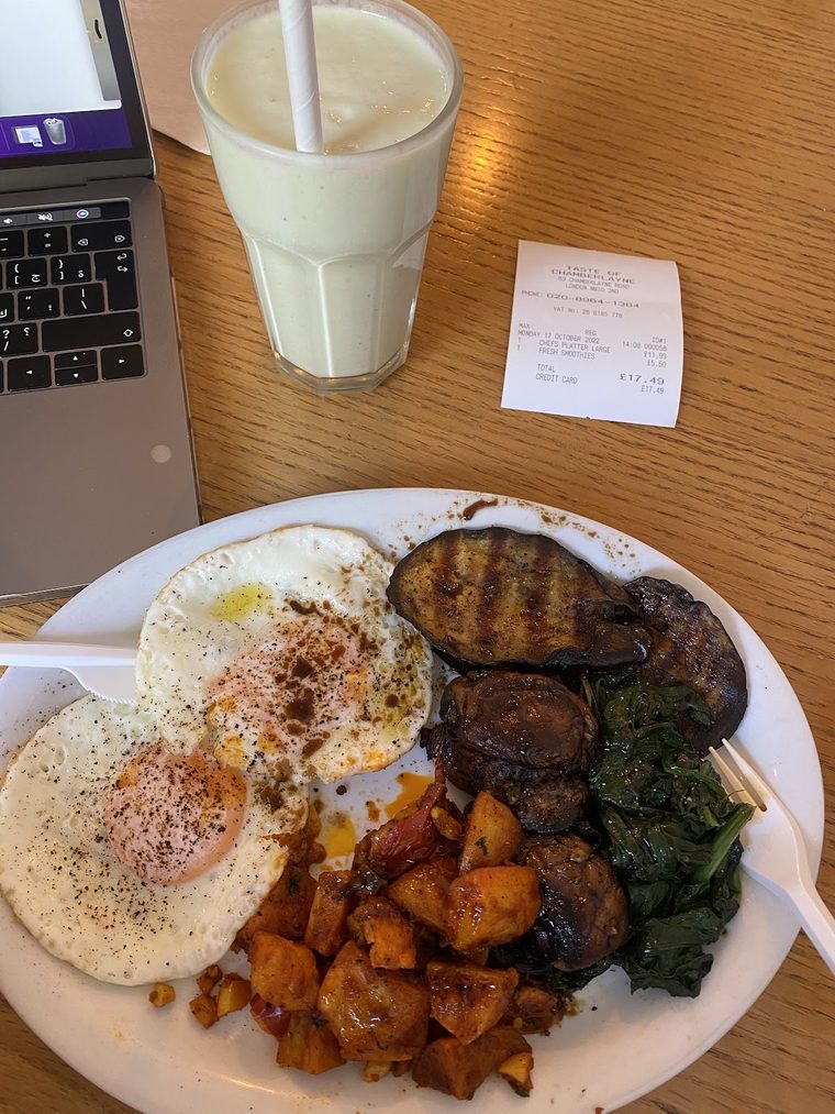Fried eggs with grilled aubergine, spinach and spiced potatoes, with an iced coffee alongside